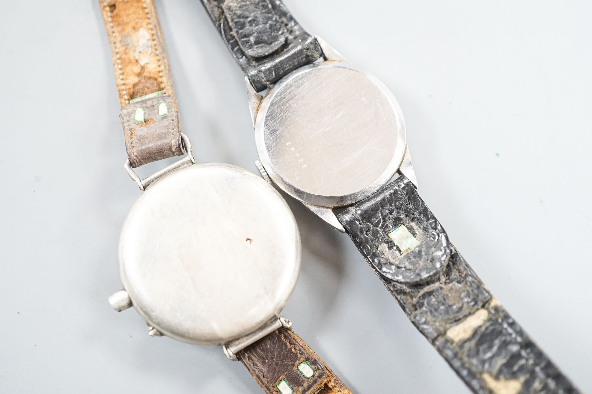 A gentleman's stainless steel Jaeger LeCoultre manual wind wrist watch, case back numbered 64765, on associated strap and a white metal fob watch, now mounted as a wrist watch(a.f.).